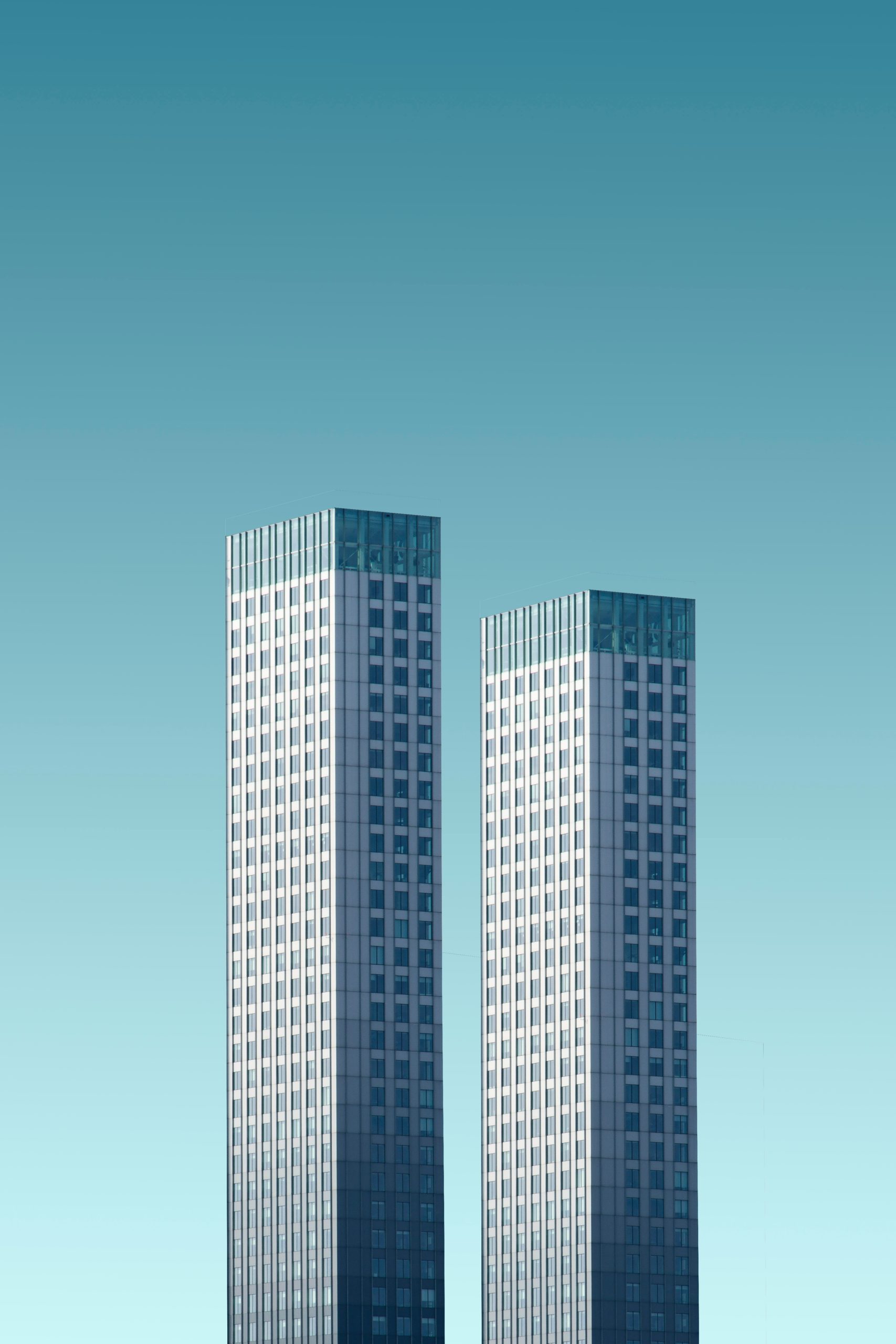 two teal-and-white skyscrapers